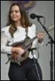 A person playing a guitar and a microphone

Description automatically generated