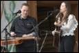 A person and person playing guitar and singing

Description automatically generated