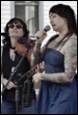 A person singing into a microphone

Description automatically generated