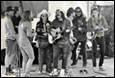 A group of people playing instruments

Description automatically generated