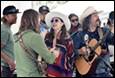 A group of people playing instruments

Description automatically generated