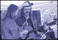 A group of men playing guitars

Description automatically generated