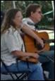 A person and person playing guitar

Description automatically generated