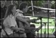 A person and person playing instruments

Description automatically generated