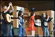 A group of people singing and playing instruments

Description automatically generated
