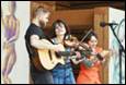 A group of people playing instruments

Description automatically generated