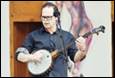 A person playing a banjo

Description automatically generated