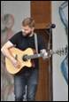 A person playing a guitar

Description automatically generated