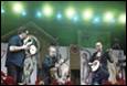 A group of people playing instruments

Description automatically generated