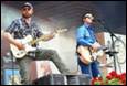 A group of men playing guitars

Description automatically generated