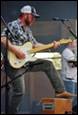 A person playing a guitar

Description automatically generated