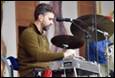A person playing a drum set

Description automatically generated