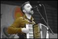 A person playing an accordion

Description automatically generated