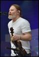 A person with a beard playing a violin

Description automatically generated