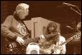 A group of people playing guitars

Description automatically generated
