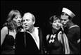 A group of people singing into a microphone

Description automatically generated