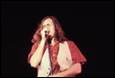 A person singing into a microphone

Description automatically generated