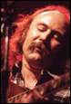A person with a mustache and a guitar

Description automatically generated
