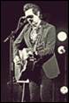 A person playing guitar and singing into a microphone

Description automatically generated with low confidence