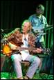 A picture containing clothing, person, musical instrument, concert

Description automatically generated