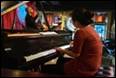 A person playing a piano

Description automatically generated with medium confidence