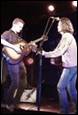 A picture containing person, guitar, concert, clothing

Description automatically generated