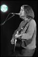 A person playing guitar and singing into a microphone

Description automatically generated with medium confidence