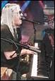 A picture containing musical instrument, concert, person, clothing

Description automatically generated