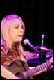 A person singing into a microphone

Description automatically generated