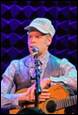 A person playing a guitar

Description automatically generated