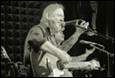 A person singing into microphones

Description automatically generated